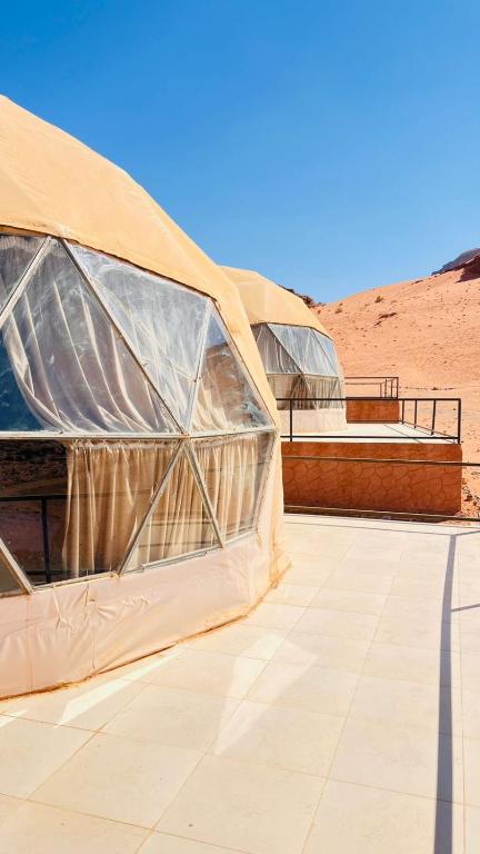 two large domes on a patio in the desert at wadi rum planet camp in Disah