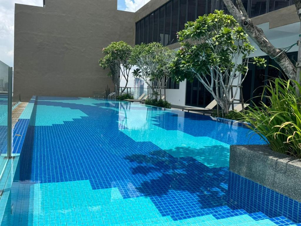 a swimming pool with blue water in a building at Majestic Luxury Residence by KLCC in Kuala Lumpur
