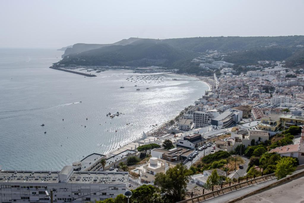 a view of a beach with boats in the water at Sesimbra Ocean Suites - Operating by Parcela Hospitaleira in Sesimbra
