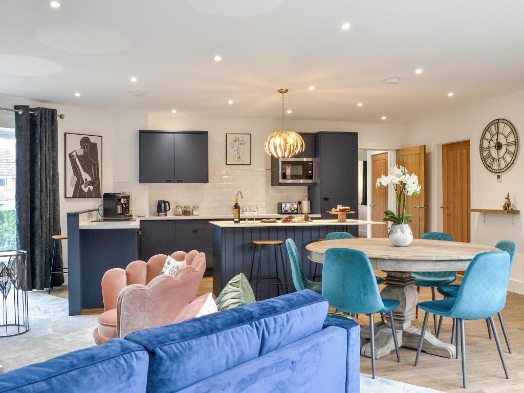 a living room with a couch and a table at West Lodge in Sewerby