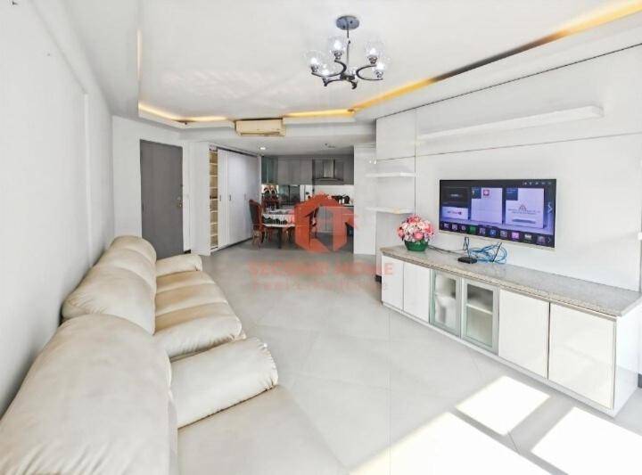 a living room with a couch and a flat screen tv at Newly Apt taman Rasuna 3BR tower 16 07 E in Jakarta