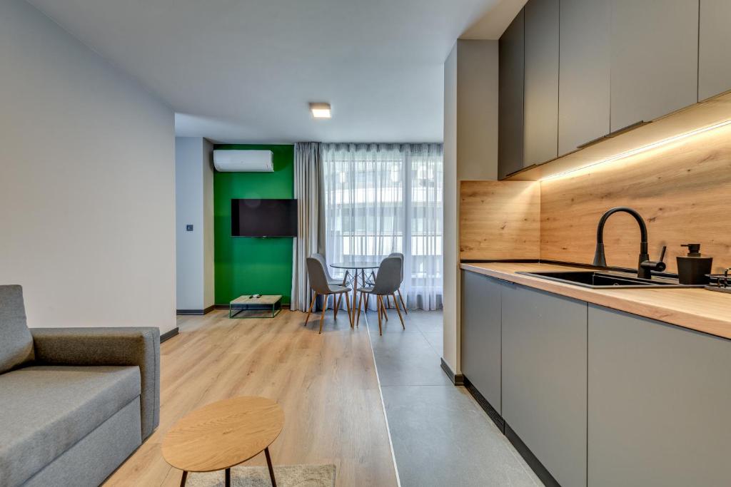 a kitchen and living room with a couch and a table at La Shara Building in Sofia