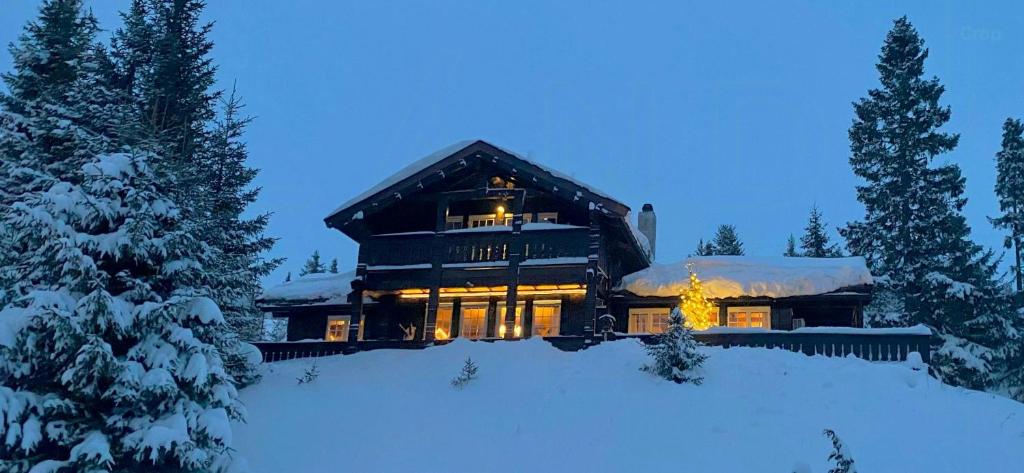 a large house in the snow at night at Spacious Family Cabin With Views In Hafjell in Hunder