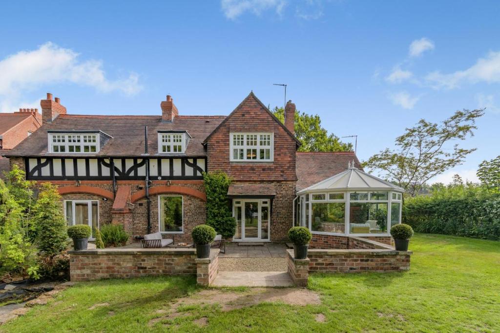 an exterior view of a house with a conservatory at 3 Bed in Thelwall oc-c29954 in Thelwall