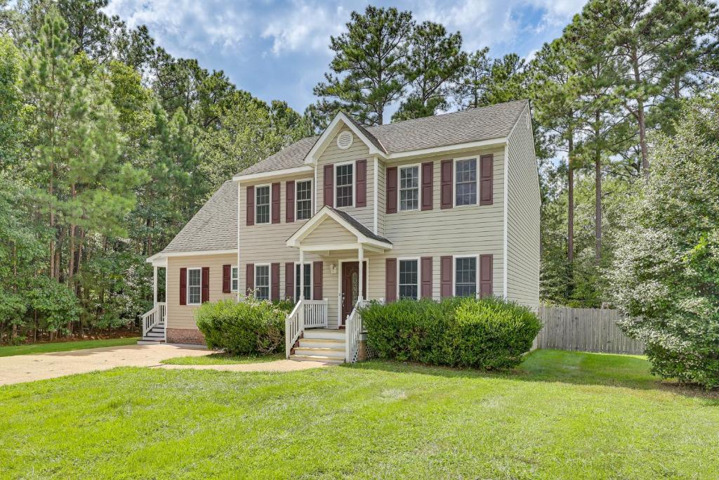 a house with a fence and a yard at Classic Colonial Home with Private Yard in Richmond! in Beulah Village