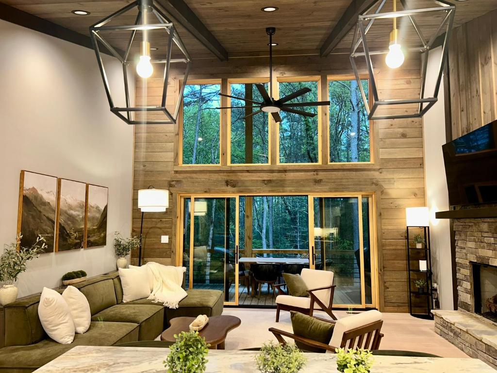 a living room with a couch and a fireplace at Lux Blue Ridge Cabin, Hot tub, Swing, PingPong! in Mineral Bluff