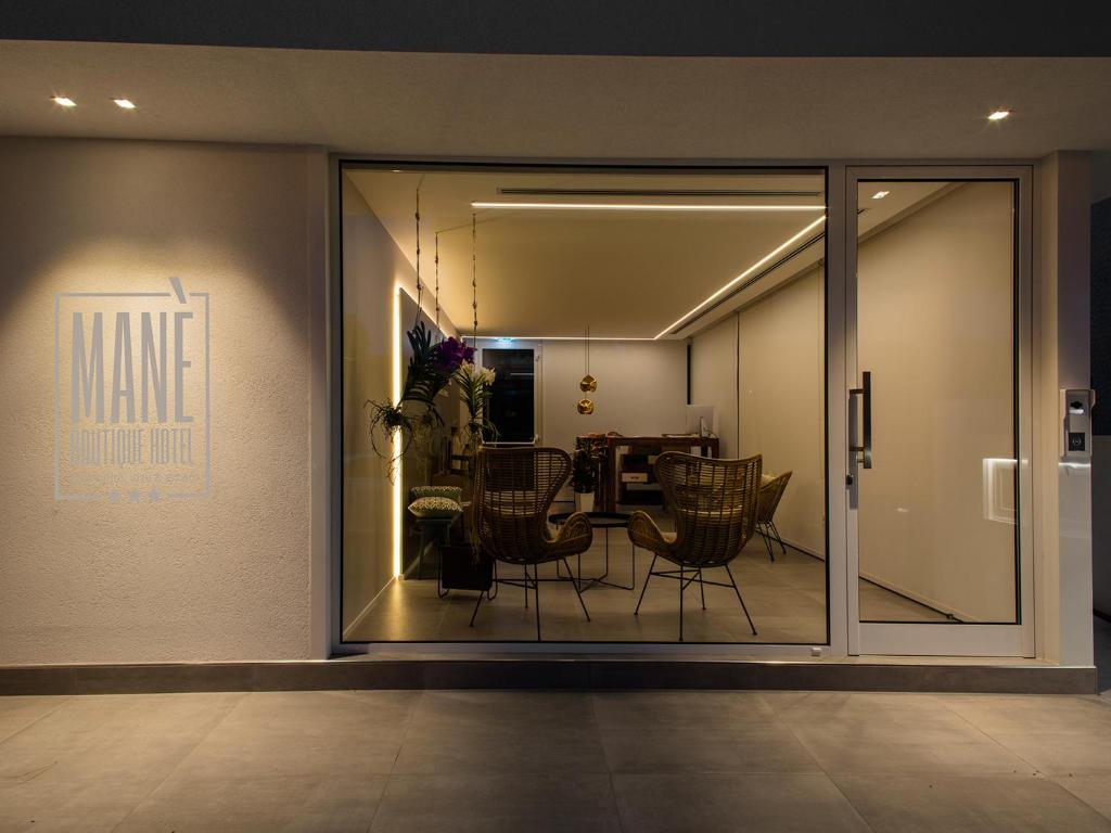 a dining room with sliding glass doors with a table and chairs at Manè Boutique Hotel in Roseto degli Abruzzi