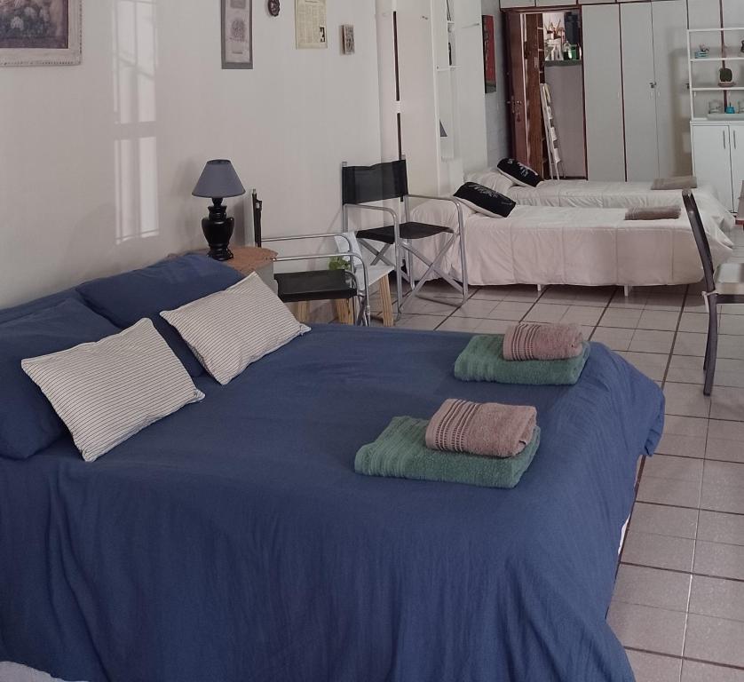 a blue bed with two towels on top of it at Monoambiente Osvaldo in Neuquén