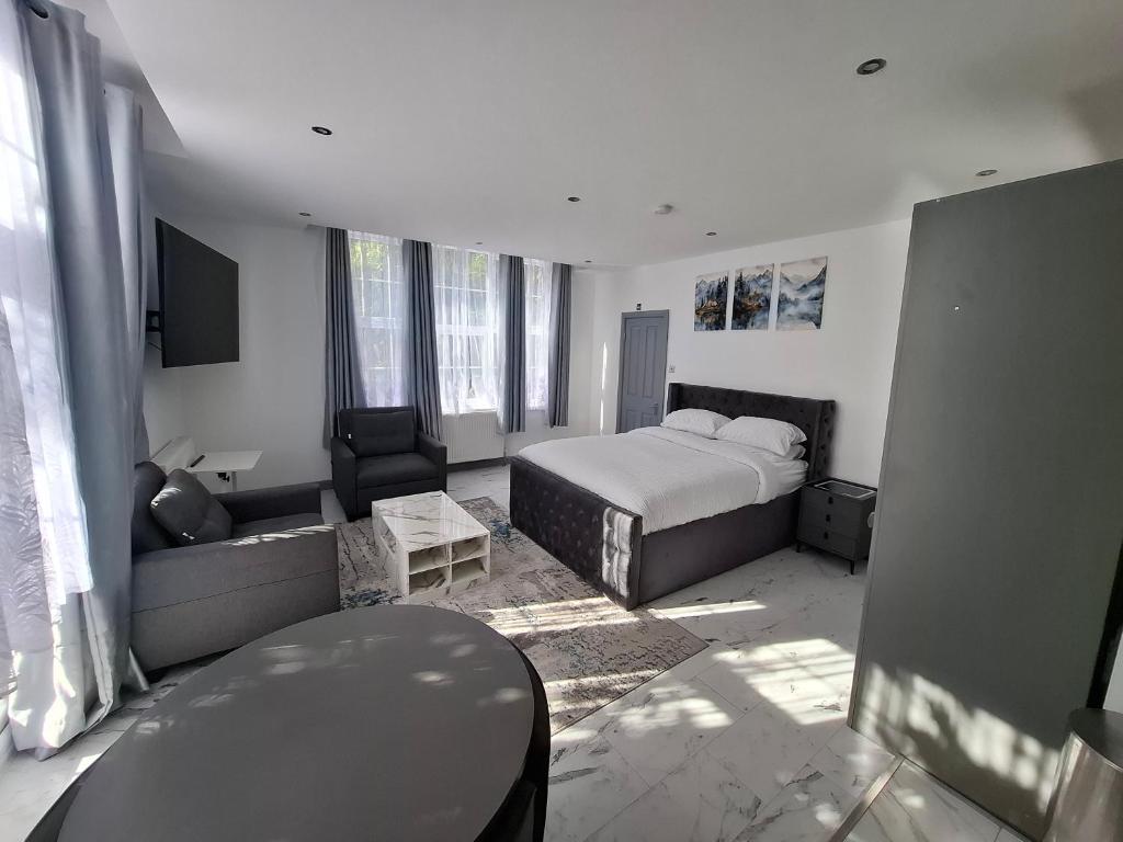 a hotel room with a bed and a couch at Guyrock Apartments in London