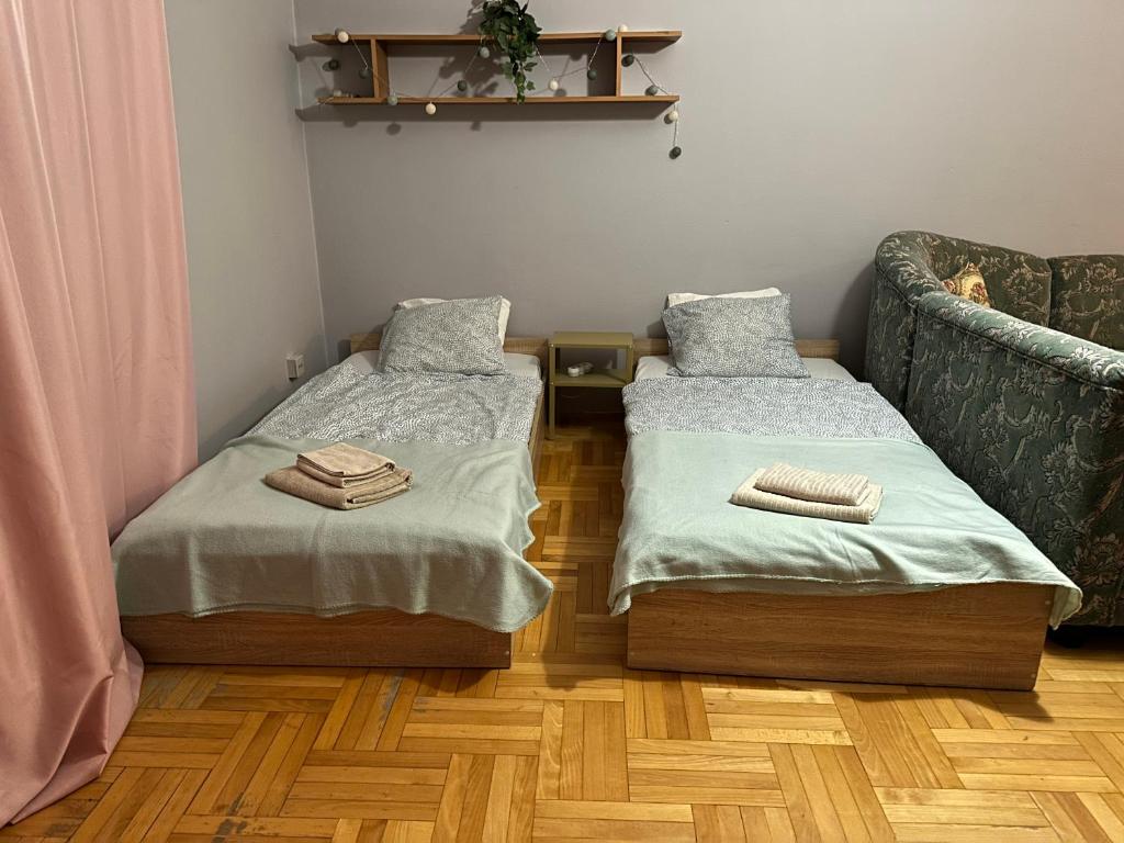 a room with two twin beds and a couch at Pokoje do wynajęcia - Podwisłocze 8a in Rzeszów