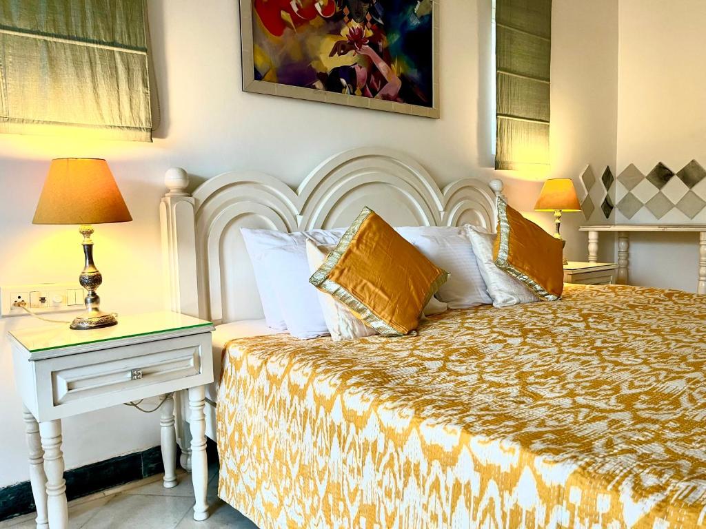 Hotel Aashray Homestay, a bedroom with a bed and a table with a night stand at Aashray Homestay in Varanasi