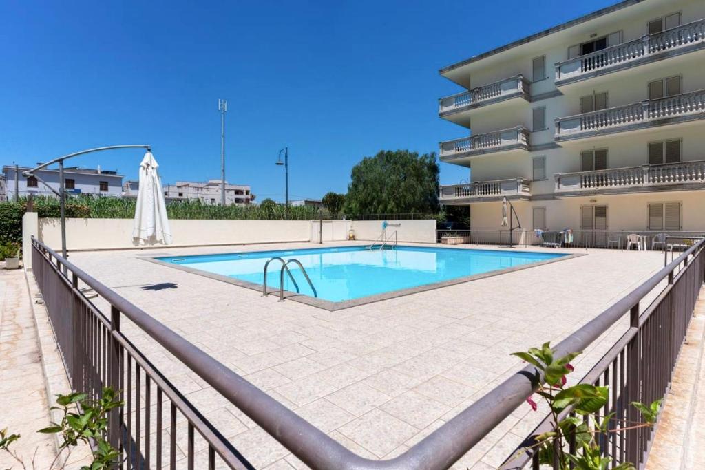 a swimming pool in front of a building at Cariddi in Caulonia Marina
