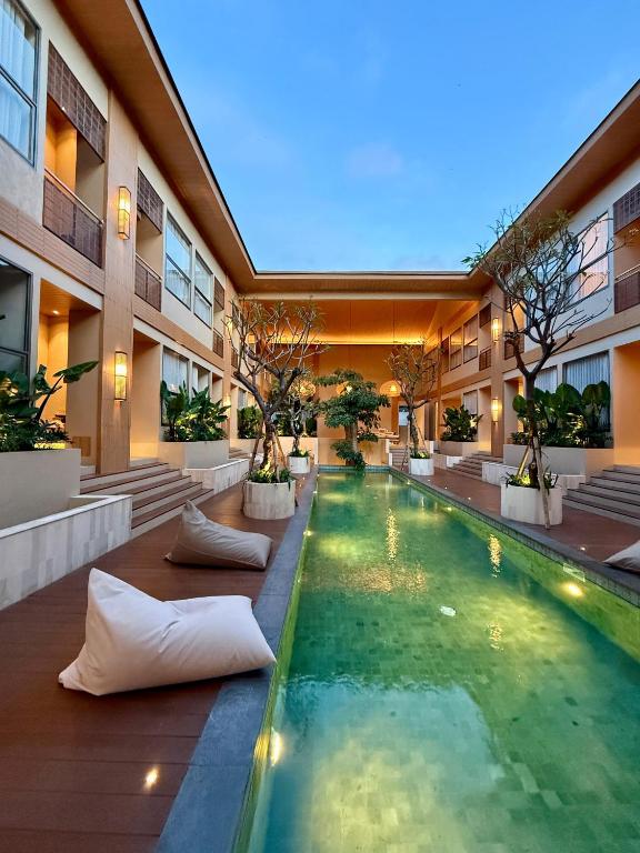 a swimming pool in the middle of a building at KAIA Canggu in Canggu