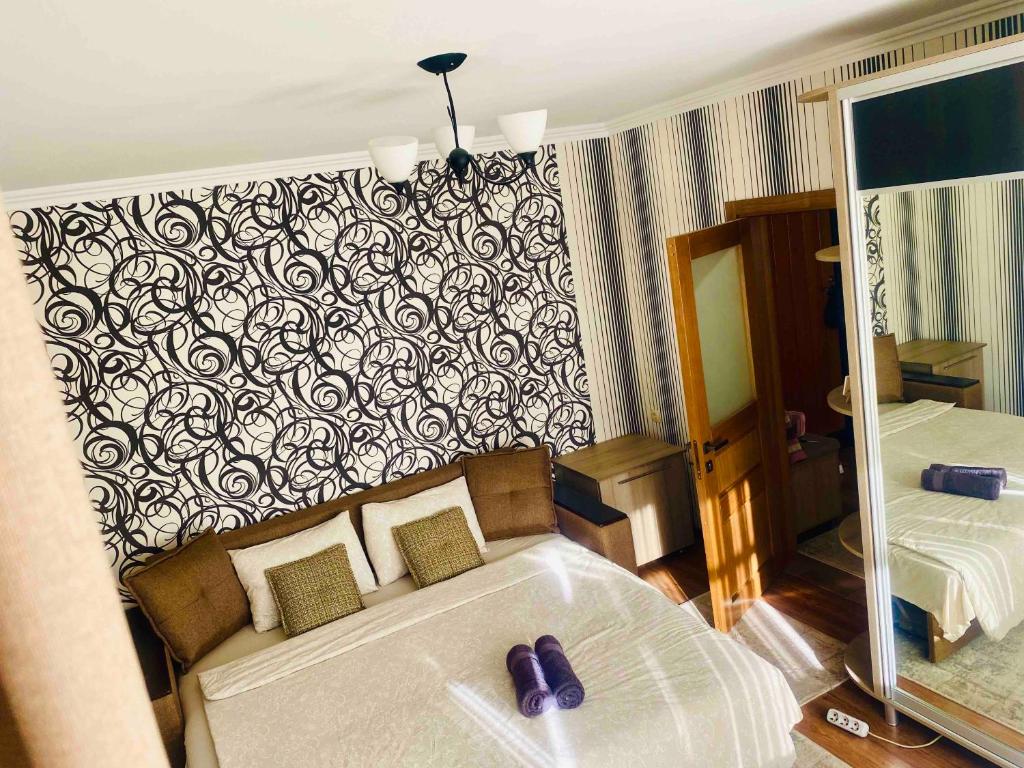 a hotel room with a bed and a mirror at Air-Moldova 25 in Chişinău