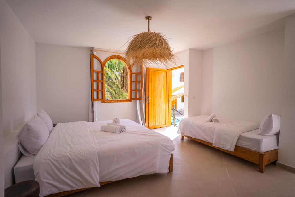 Postel nebo postele na pokoji v ubytování Riad TAWALA Surfing Mind