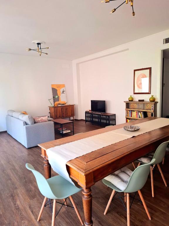 a living room with a table and chairs at Casa Mecenate in Arezzo