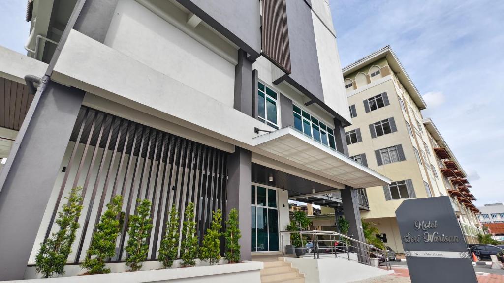 a building with a sign in front of it at Hotel Warisan in Taiping