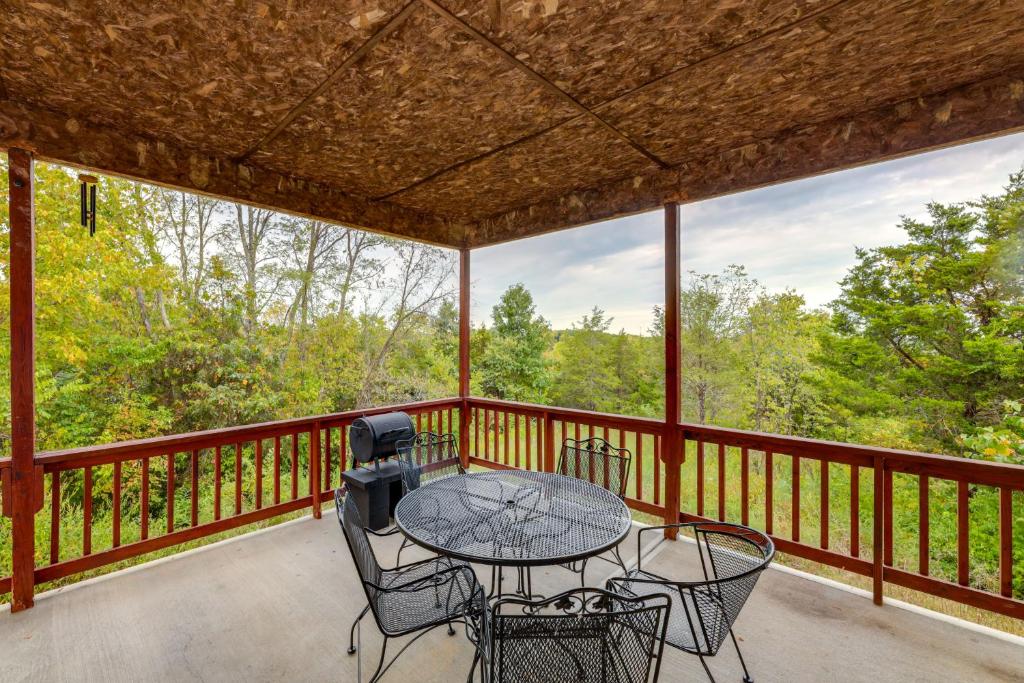 a patio with a table and chairs on a balcony at Hillside Home 5 Mi to the Ark in Williamstown! in Corinth