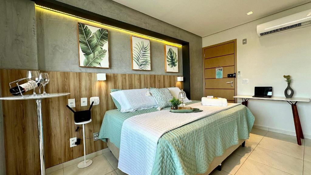 a bedroom with a bed with a green comforter at (106) Studio Inesquecível em espaço Moderno in Vinhais