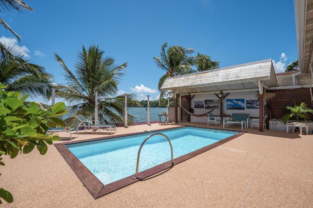 a swimming pool in front of a house at Villa Beau Rivage in La Moïse