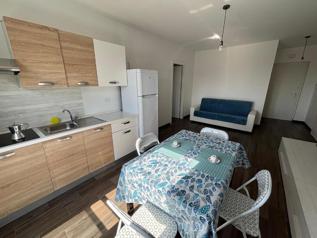 a kitchen with a table and chairs in a room at Al Bivio Blu in Chieti