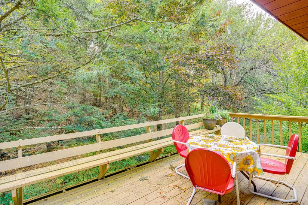 a patio with a table and chairs on a deck at Quiet All-Season Creekside Escape in Upstate! in North Hancock