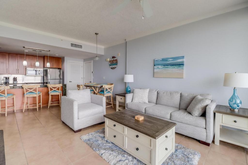 a living room with a couch and a table at The Driftwood Oasis in Biloxi