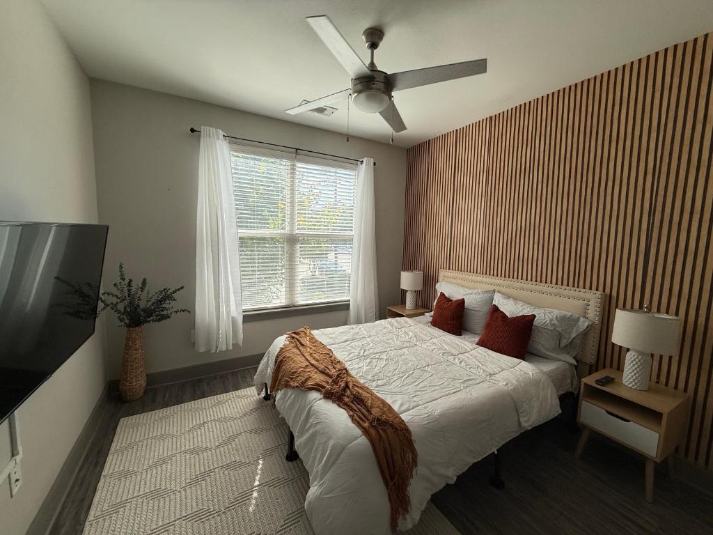 una camera da letto con un letto e un ventilatore a soffitto di Large Buckhead modern suite ad Atlanta