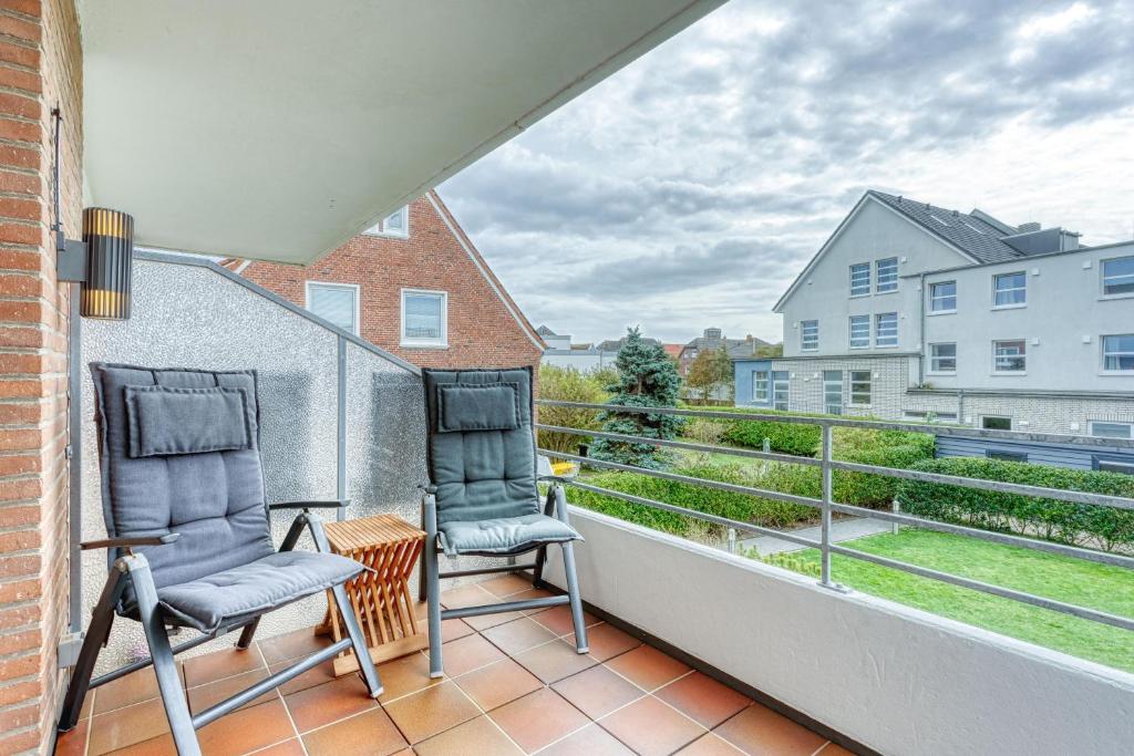 two chairs on the balcony of a apartment at Meerzeit Norderney in Norderney
