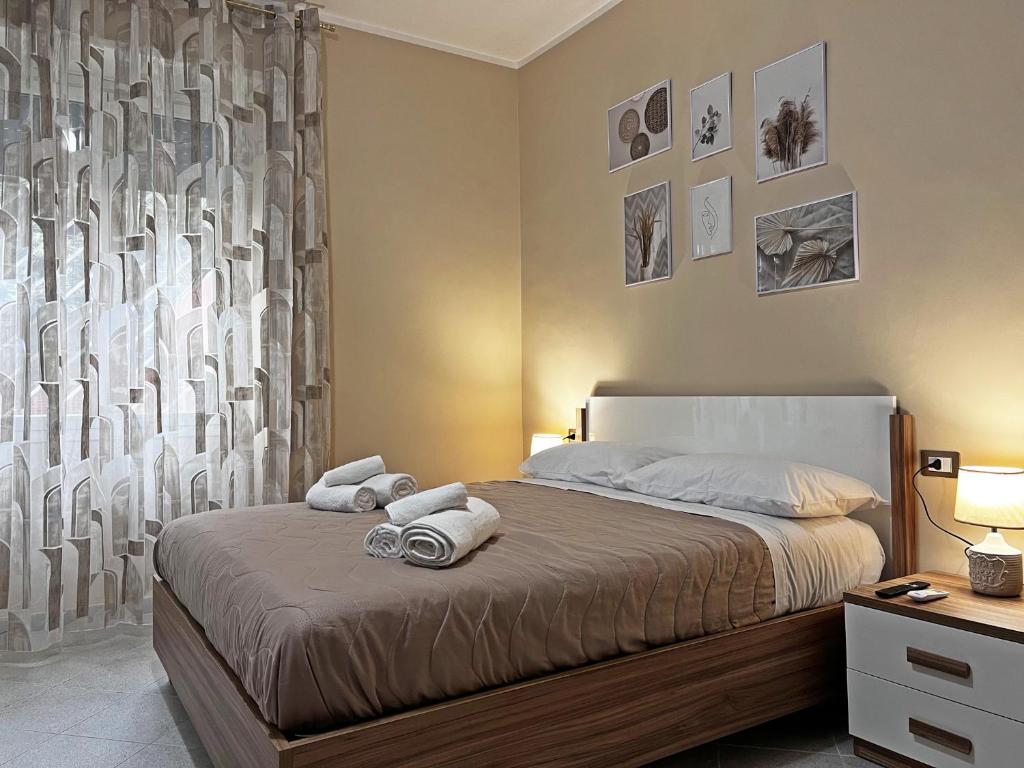 a bedroom with a bed with towels on it at Maison DomInes in Ciampino