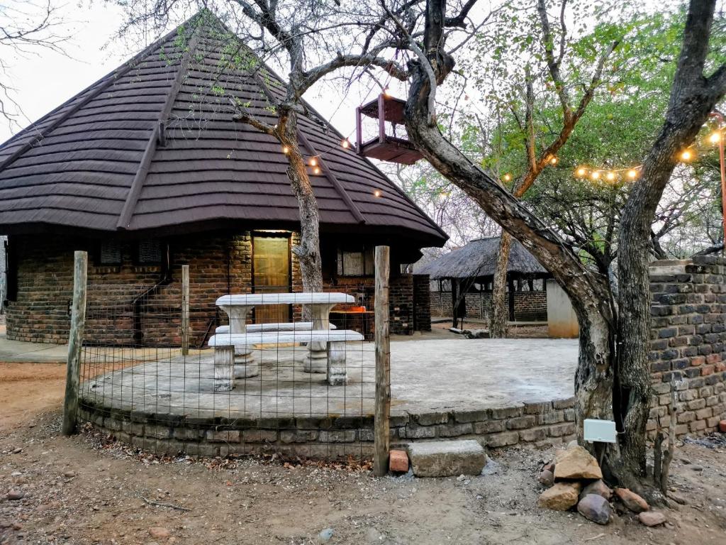 a building with a picnic table in front of it at Chip n Debs Kruger Vacations in Marloth Park