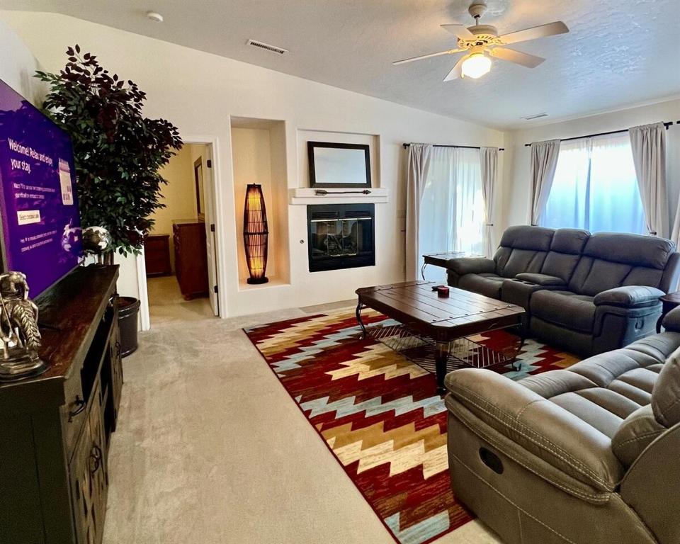 a living room with a couch and a table at Large Prescott Home with 3-car Garage Central & Quiet in Prescott