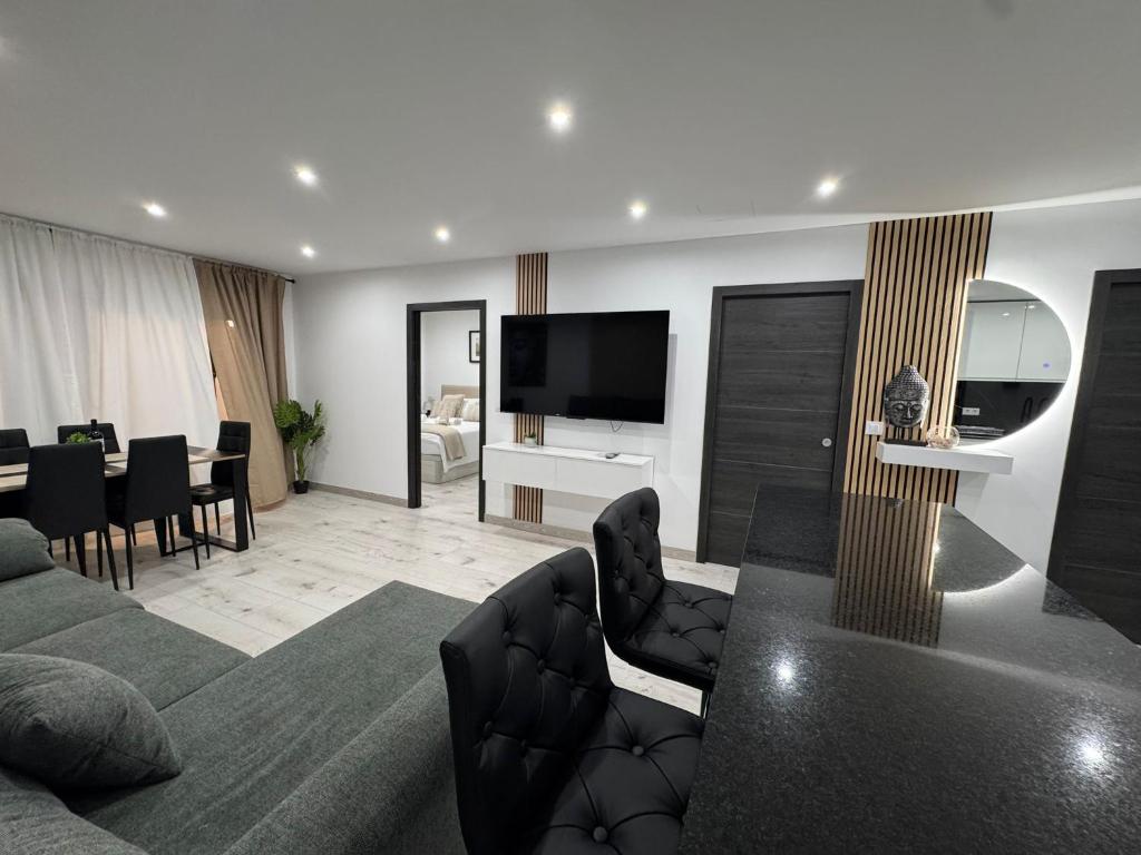 a living room with a couch and a dining room at Apartamento de lujo N&C con terraza - Playa Arenal Bol in Calpe