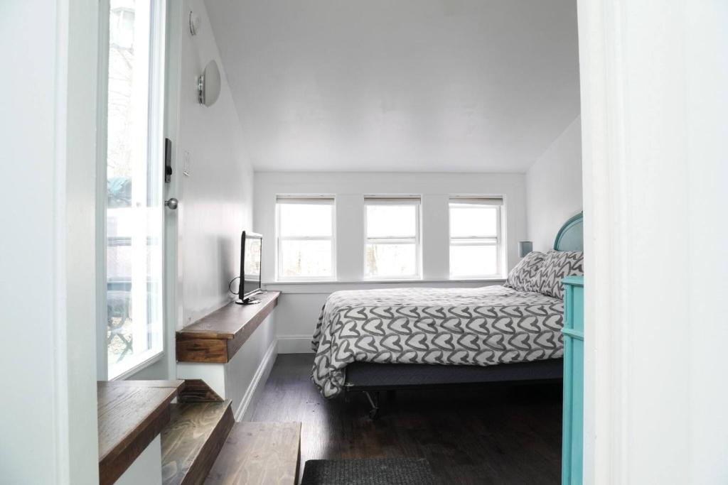 a bedroom with a bed and two windows at Unique private room and bath in Halifax