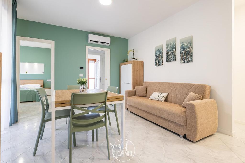a living room with a couch and a table at L' Oasi Verde in Pirri