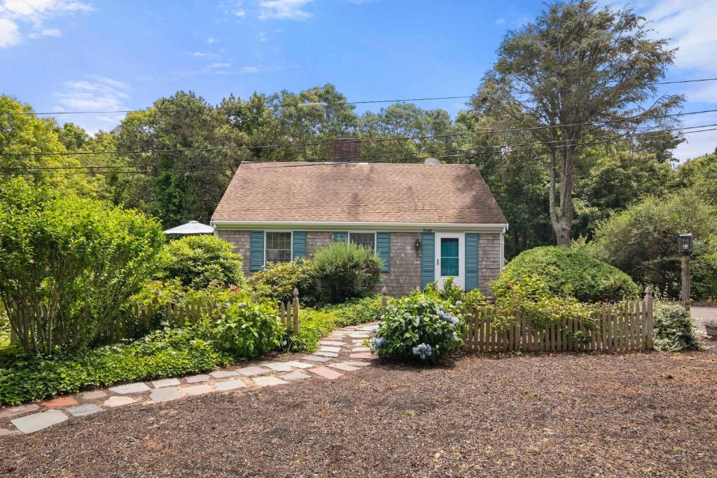 a small house with a fence in a yard at Great location with Water Views in Harwich