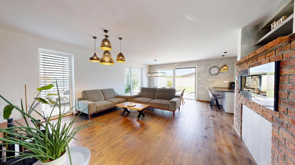 a living room with a couch and a table at Exkluzívny rodinný dom Trnava - rodiny, pracovné cesty in Trnava