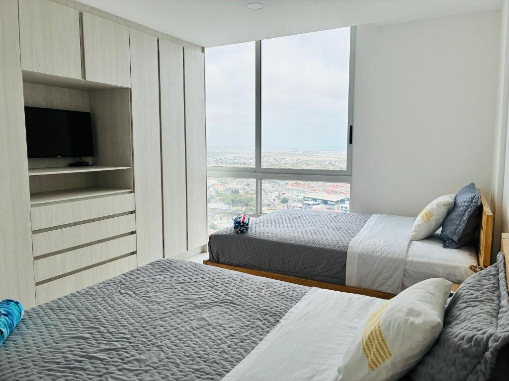 Ένα ή περισσότερα κρεβάτια σε δωμάτιο στο Infinity View Salinas By SeaSky de Perla Azul