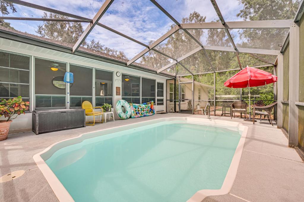 a swimming pool in a house with a glass roof at Dog-Friendly Home, Lake Henderson Across Street! in Inverness