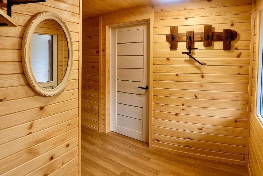 a wooden room with a mirror and a door at DubOk in Yaremche