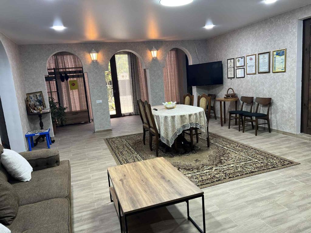 a living room with a table and a couch at Guest Hause Lile in Tsʼageri