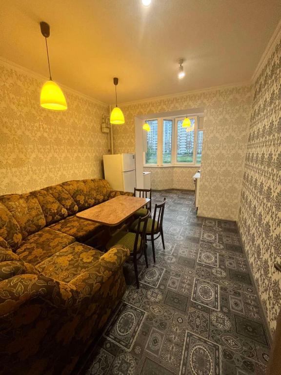 a living room with a couch and a table at Апартаменты у моря 60м2 in Kryzhanivka
