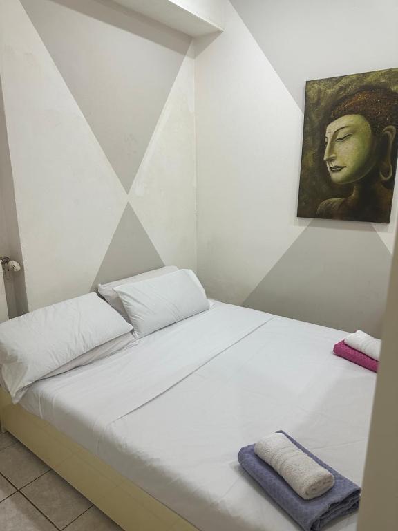 a bed in a room with a painting on the wall at Stazione Di Corticella in Bologna