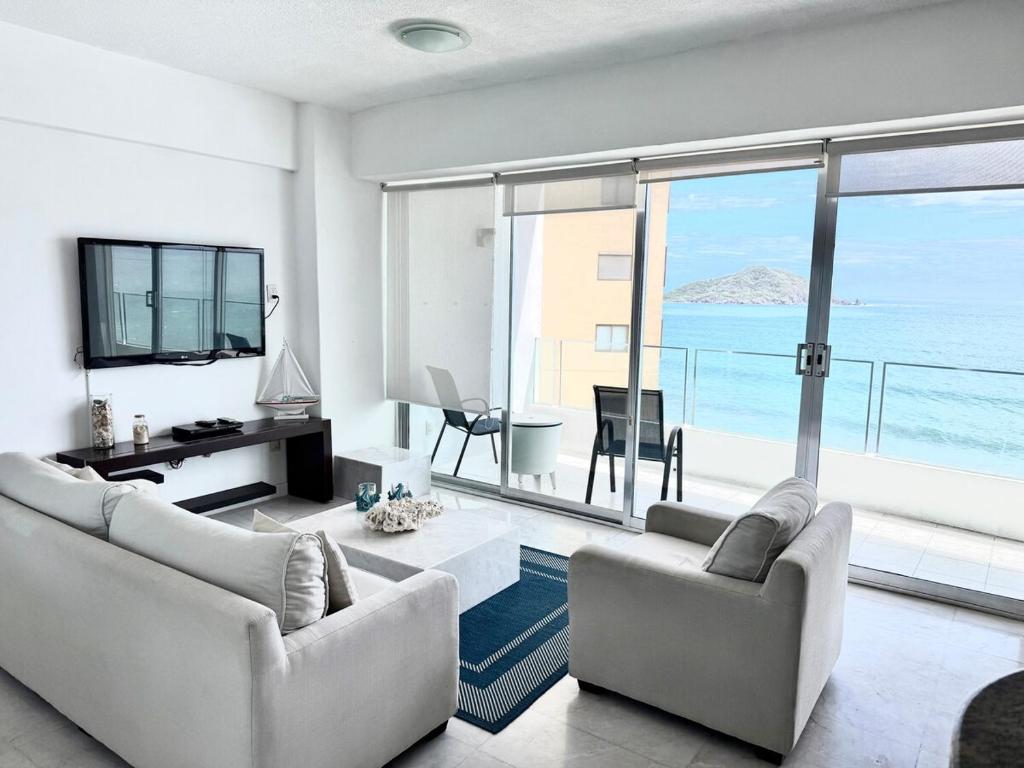 a living room with two couches and a view of the ocean at Park Royal 809 Vista al Mar in Mazatlán