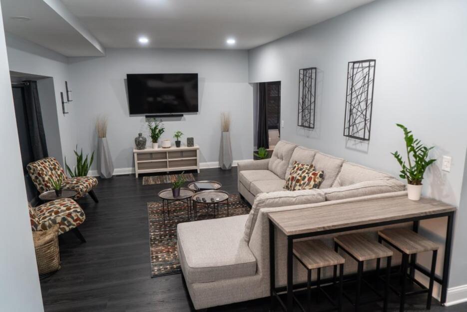 a living room with a couch and a tv at Modern 3BDRM, Renovated, Spacious & Central in Evansville