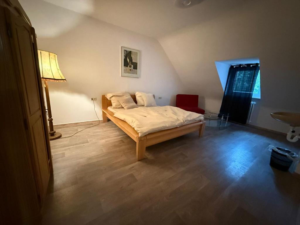 a bedroom with a bed in the corner of a room at Gemütliches Buchen Zimmer mit Gemeinschaftsbad in Karlsruhe