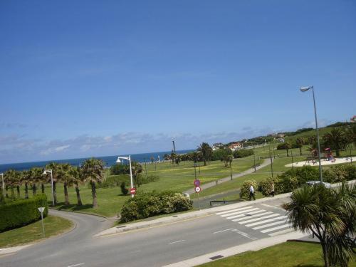 an empty street in a park next to the ocean at Hotel Begoña Park in Gijón
