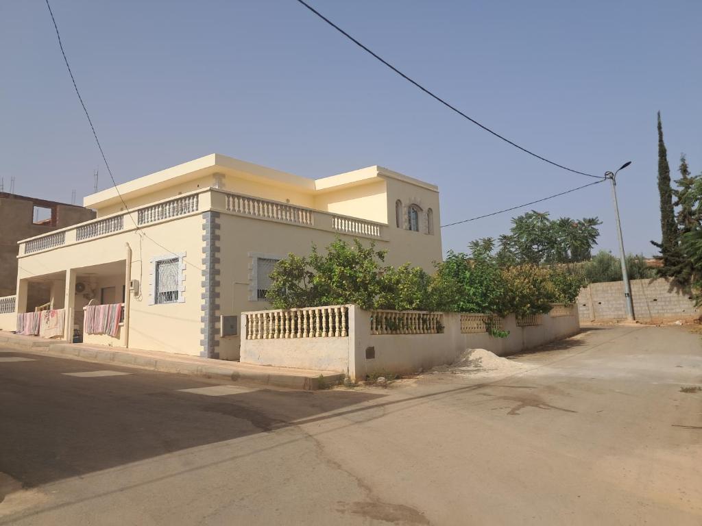 a white house with a fence in front of it at Tlemcen in Ghazaouet
