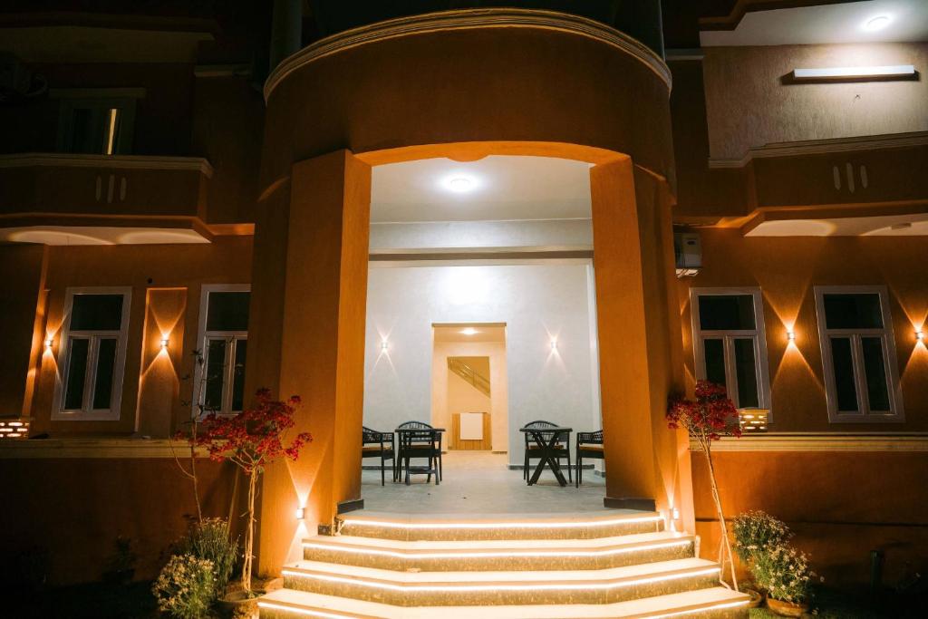 an entrance to a building with stairs and lights at Florya pyramids hotel in Cairo