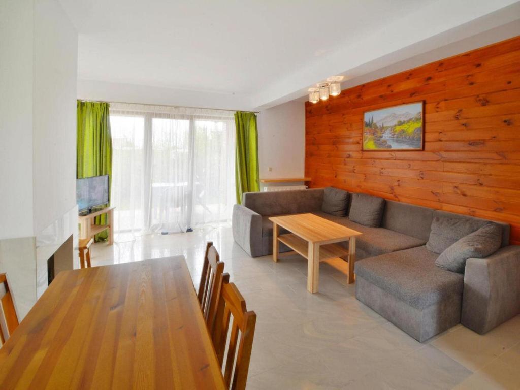 a living room with a couch and a table at Terraced House in Sarbinowo near the Beach in Sarbinowo